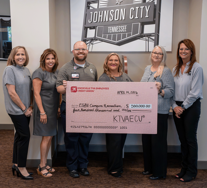 KTVAECU staff holding sponsorship check.