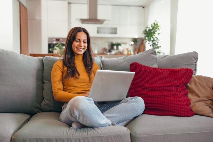 Lady making a loan payment on her laptop.