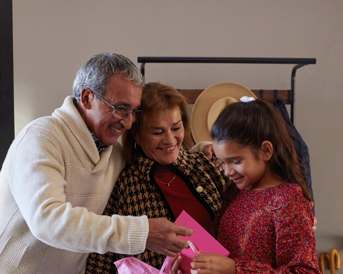 Wealth Management Banner - grandparents giving young girl a gift.