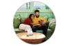 Young couple sitting on couch and petting dog