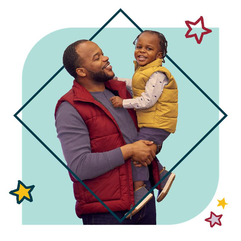 Man holding his son and smiling