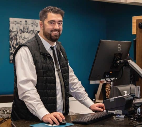KTVAECU male staff member standing at a Northshore Branch pod and smiling
