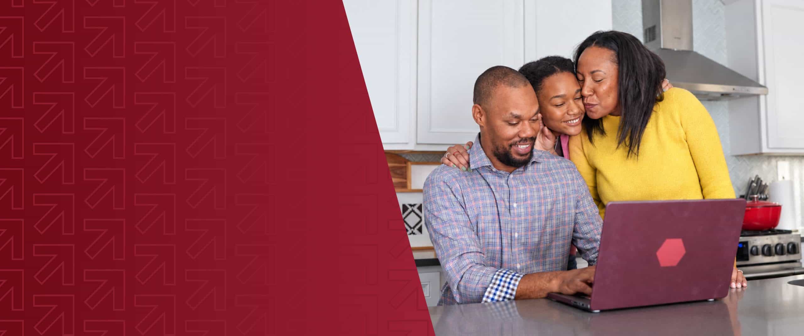 Family enjoying time together while using a laptop in the kitchen.