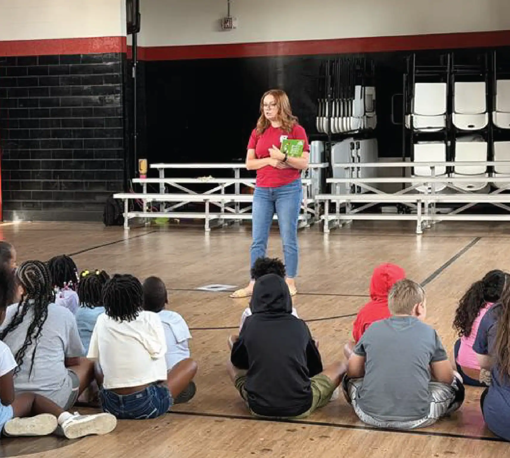 KTVAECU Employee leading a financial literacy workshop to a group of young children