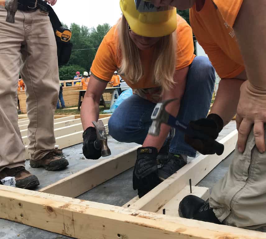 KTVAECU staff member hammering part of a new frame for a Habit for Humanity build