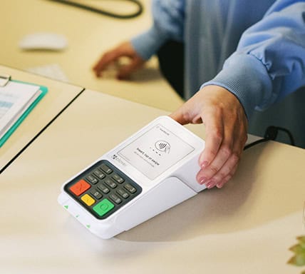 Employee holding a Clover Point-of-Sale System