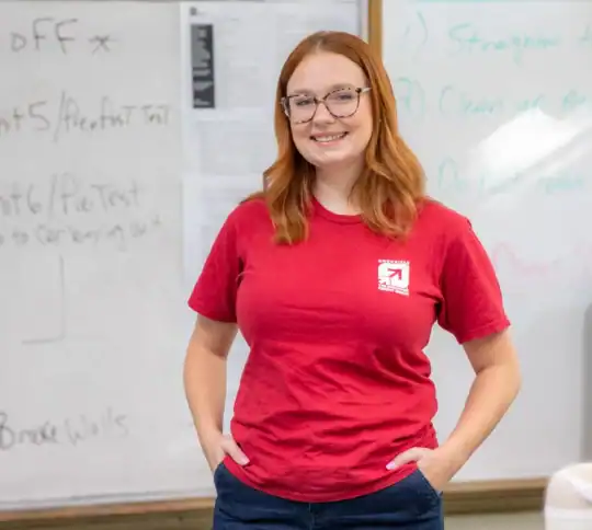 Brooke Wells standing in classroom smiling