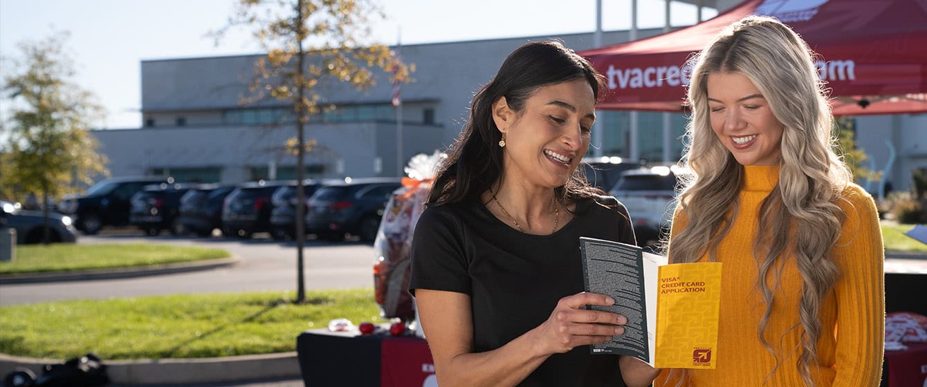 KTVAECU Teller helping Member with Credit Card application at an event