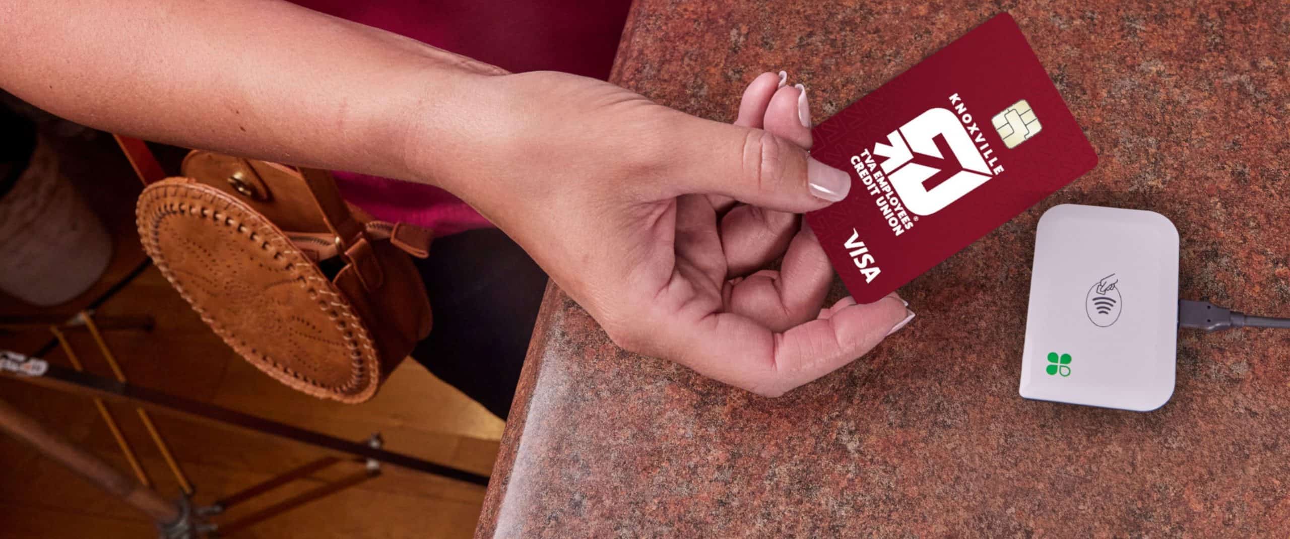 Customer tapping KTVAECU credit card on a Clover POS system