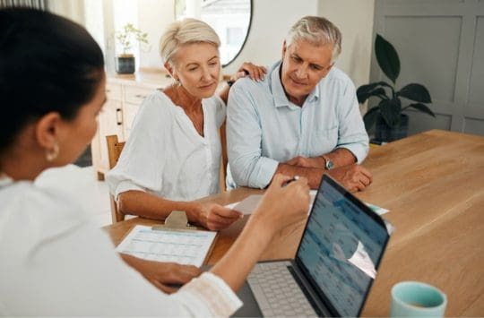 Older couple talking with a financial advisor