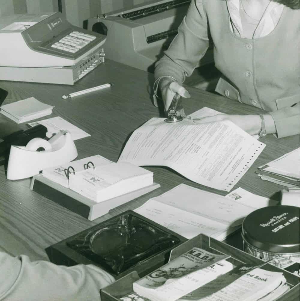 An overhead view of people filling out forms.