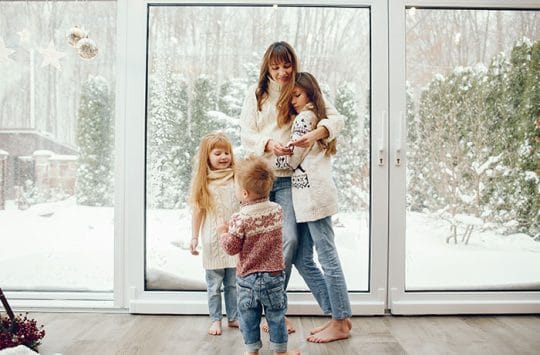 Mother and children in their home during winter.