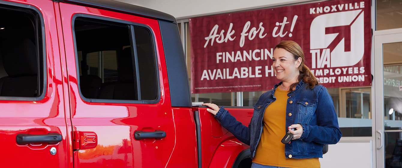Woman buying a Jeep at a KTVAECU Preferred Dealership.